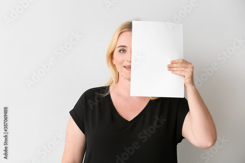 Woman with blank paper shee...