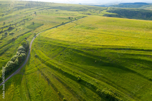 Aerial view of countryside vibrant green hills. Transylvania, Romania