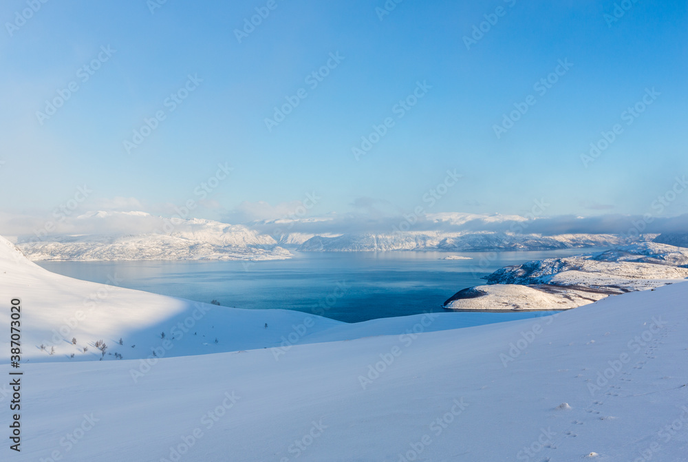 Beautiful winter landscape with mountains and fjord