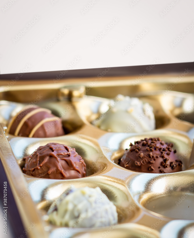 a box of round belgian or swiss chocolate candies close up, praline for confectionery advertising a box of round belgian or swiss chocolate candies close up, praline for confectionery advertising