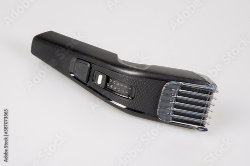 black modern electric hair clipper on white background table in hairdresser shop barber