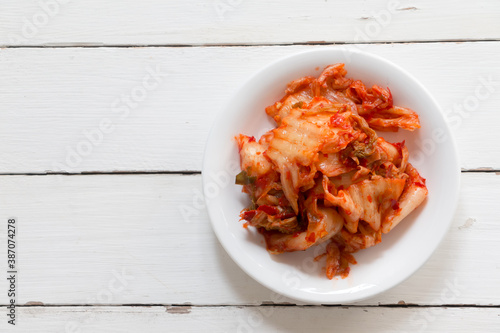 Close up shot Kimchi or Kimchee. Korean Traditional Food on white wooden table. Top view with Copy space