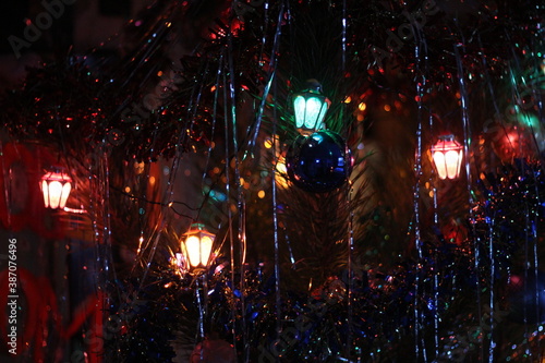 Fototapeta Naklejka Na Ścianę i Meble -  beautiful garland on christmas tree close up