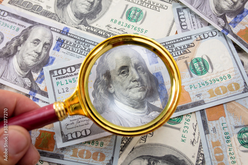 Close-up of one hundred dollars in a magnifier.