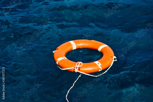An Orange Lifebuoy Floating in the Middle of the Ocean