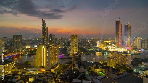 4k time-lapse video, Chao Phraya River viewpoint, Bangkok, Thailand from a high angle with nighttime water traffic, and New Year's Eve celebrations High-rise buildings adorned with light show.	
