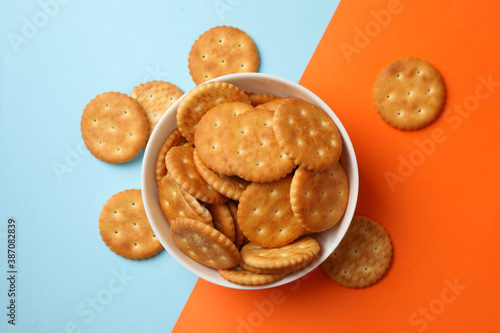 Bowl with cracker biscuits on two tone background photo