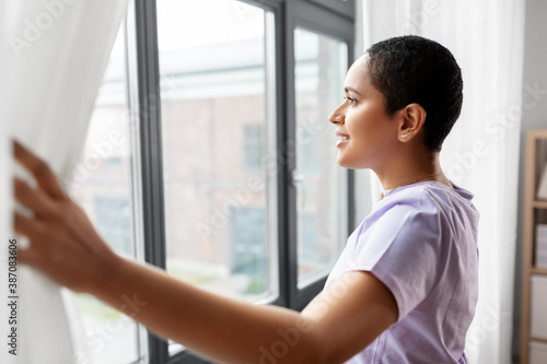 people and leisure concept - happy young african american woman looking out of window at home Free Download people and leisure concept - happy young african american woman looking out of window at home - GFXLoad