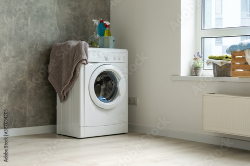 Contemporary luxury laundry in a brand new apartment in white.