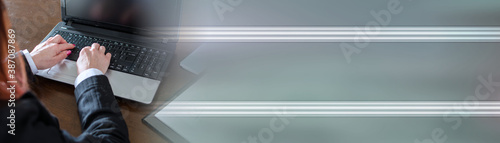Businesswoman typing on a laptop; panoramic banner