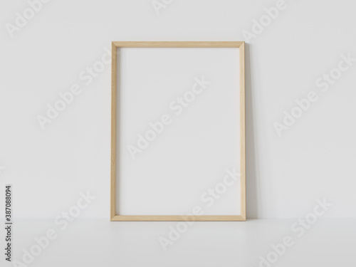 Fotografie Wooden frame leaning on white floor in interior mockup