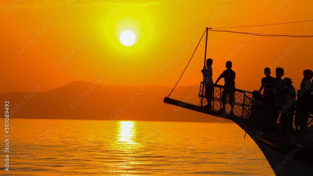 Silhouette of people on a yacht, silhouette of people on ship at sunset 