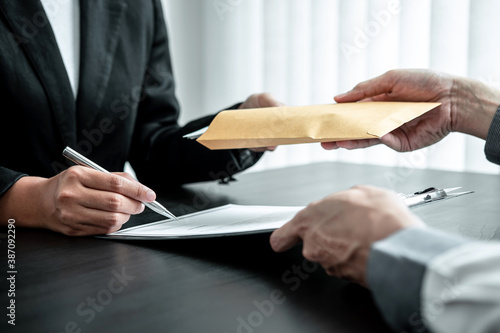 Tableau sur toile Businessman giving bribe money in the envelope to businesswoman to bribing deal