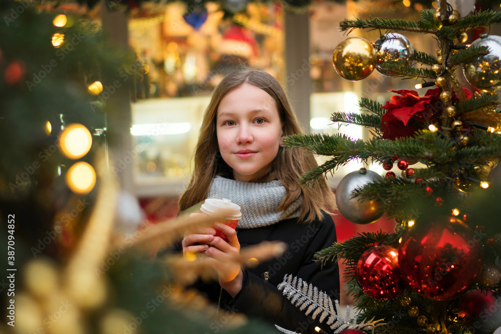 Happy teen girl with coffee at christmas market in evening. winter holidays, hot drinks and people concept. Merry Christmas and Happy Holidays. Christmas eve