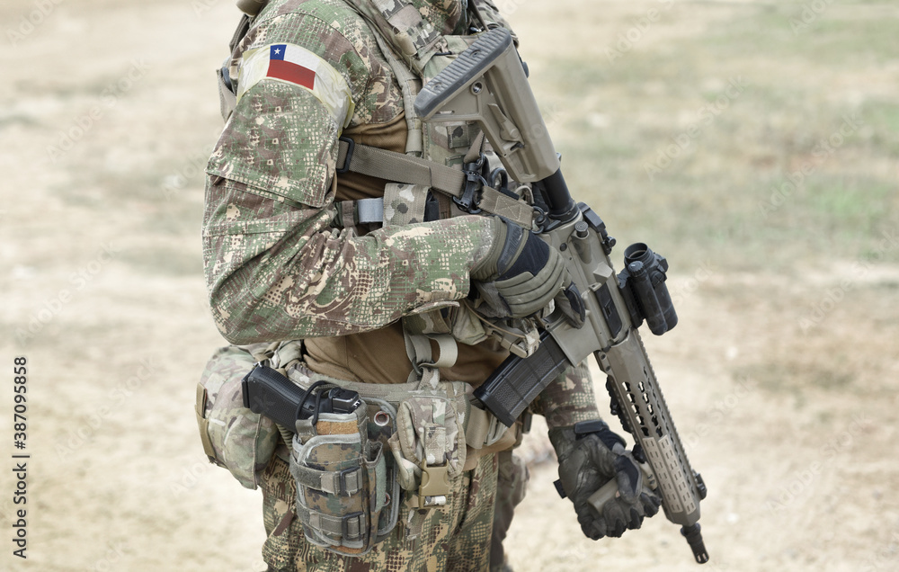 Fototapeta premium Soldier with assault rifle and flag of Chile on military uniform. Collage.