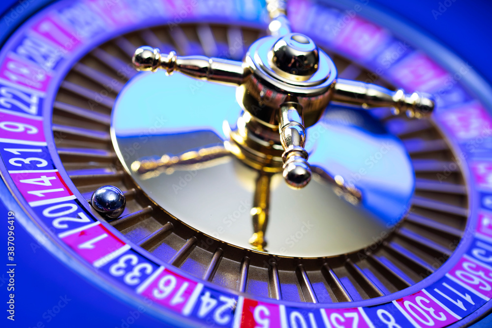 Casino theme, close up of roulette, red and black numbers. Blue background. Casino theme, close up of roulette, red and black numbers. Blue background.
