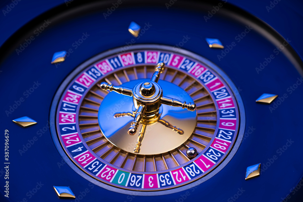 Casino theme, close up of roulette, red and black numbers. Blue background. Casino theme, close up of roulette, red and black numbers. Blue background.