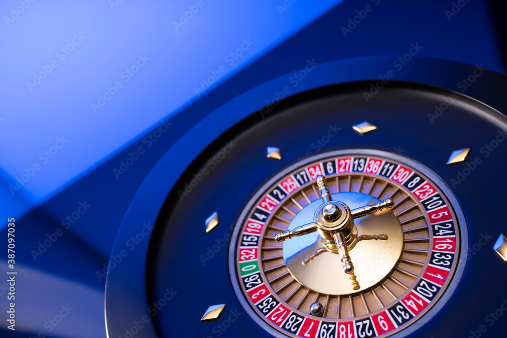 Casino theme, close up of roulette, red and black numbers. Blue background. Casino theme, close up of roulette, red and black numbers. Blue background.