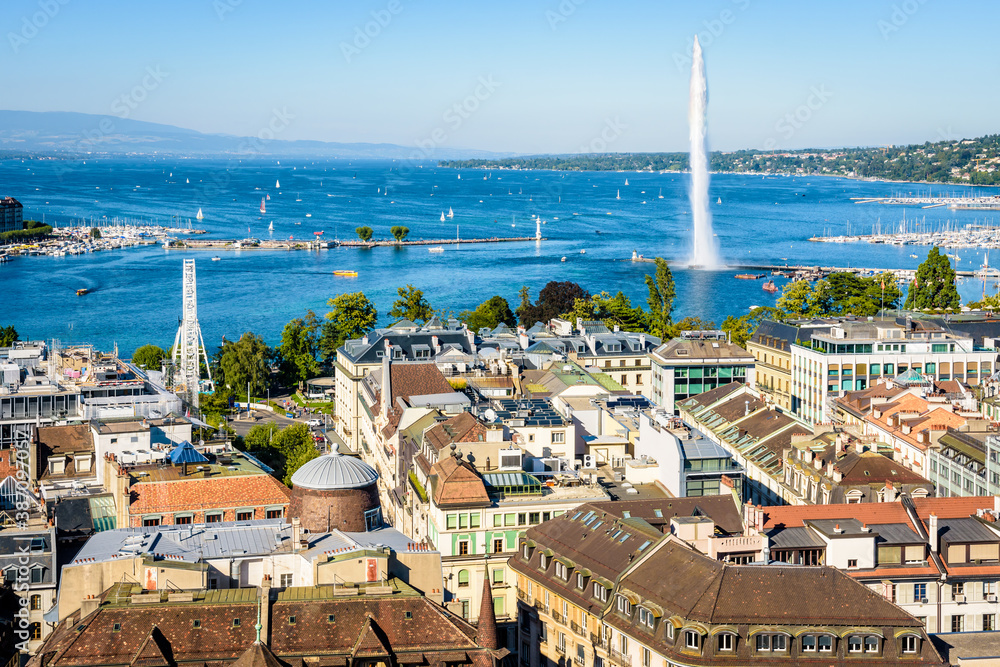 Aerial view over the rooftops of the Geneva, Switzerland, the bay of Geneva and the Lake Geneva from the bell tower of Saint-Pierre cathedral on a sunny summer day.