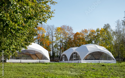 white wedding or party tent in the field. Outdoor corporate event