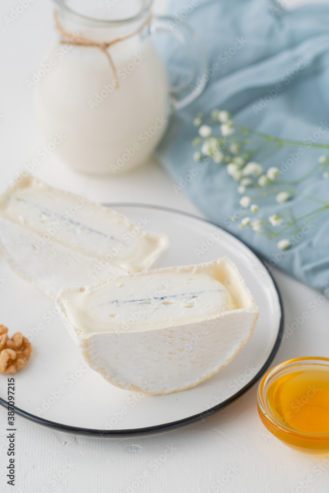 traditional cheese with white and blue mold in the section. Large pieces of sliced cheese on a light table traditional cheese with white and blue mold in the section. Large pieces of sliced cheese on a light table