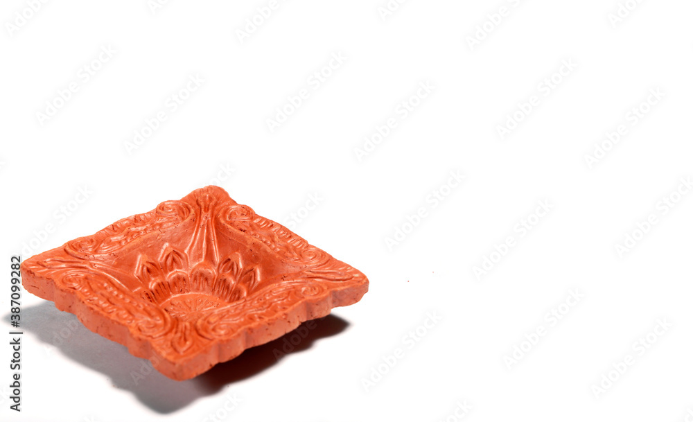Close up of a beautifully designer handmade clay lamp isolated on white background Close up of a beautifully designer handmade clay lamp isolated on white background