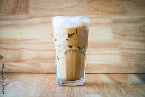 Iced coffee on a woodon table with a wood background photo