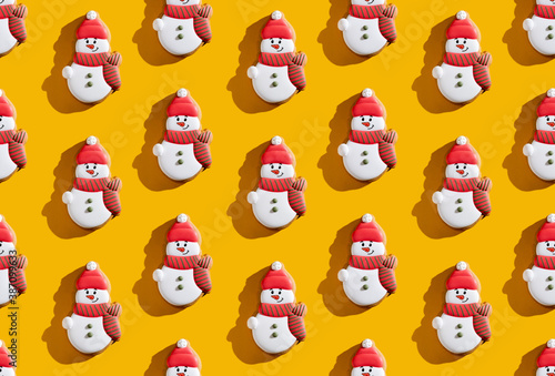 Orange Xmas background. Snowman seamless pattern. Winter holidays decoration. Cute fun white red minimalist festive design for kids isolated on bright yellow. © golubovy