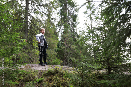 Boy posing in summer forest