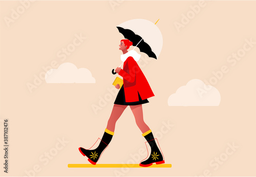 Happy girl walking in the rain. Modern flat vector concept illustration of a young fashionable woman holding an umbrella, wearing rubber boots. Happy autumn.