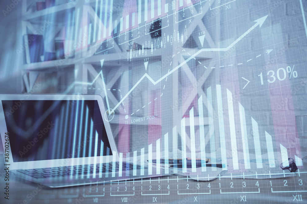 Naklejka premium Forex market chart hologram and personal computer background. Double exposure. Concept of investment.