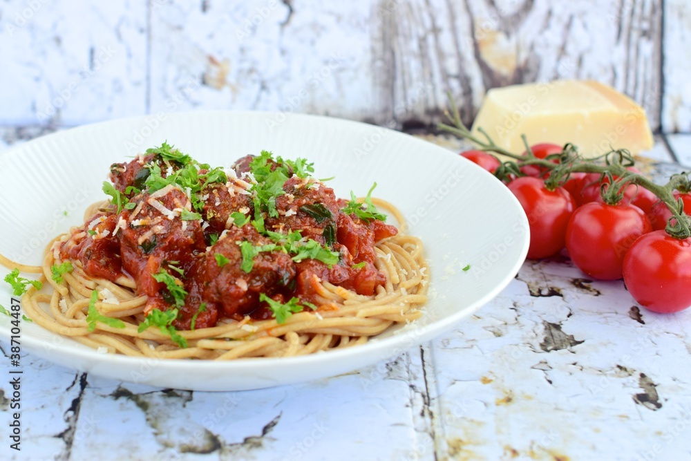 spaghetti with meatballs in tomato sauce garnish with parmesan cheese and parsley spaghetti with meatballs in tomato sauce garnish with parmesan cheese and parsley