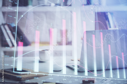 Stock market graph and table with computer background. Double exposure. Concept of financial analysis.