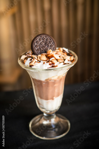 chocolate ice-cream sundae with buscuit ontop for decor