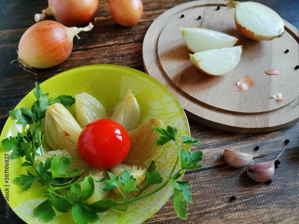 composition of baked onions, whole onions and sliced on a wooden table composition of baked onions, whole onions and sliced on a wooden table