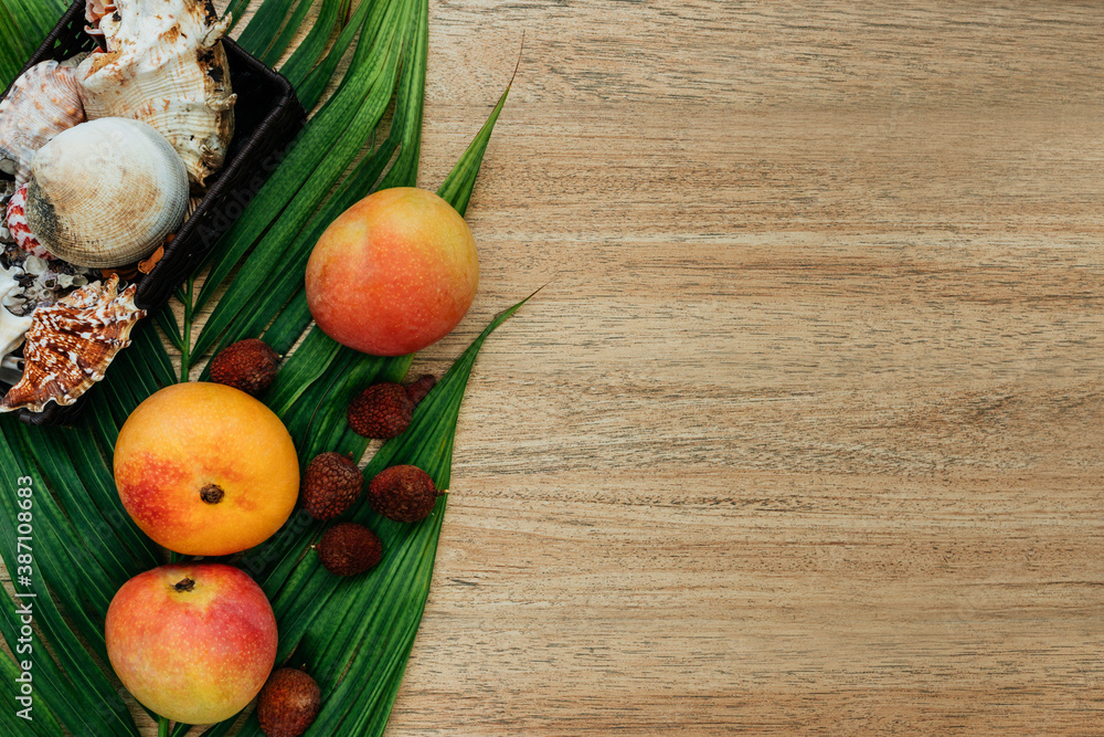 Flat lay, top view, Mix of Exotic fruits on a brown background: mangoes, lychee, fruits. healthy diet. Vegetarianism Flat lay, top view, Mix of Exotic fruits on a brown background: mangoes, lychee, fruits. healthy diet. Vegetarianism