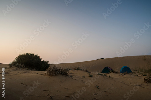 Two tents camping in the middle of vast sand the dunes