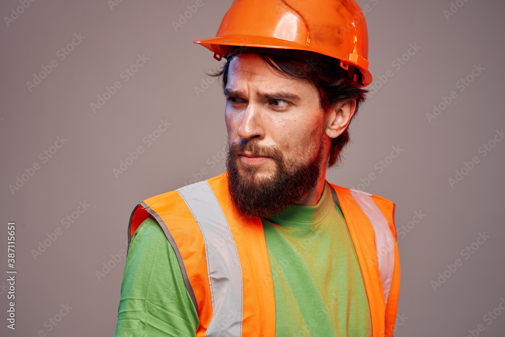 Man in working uniform orange paint safety work cropped view Man in working uniform orange paint safety work cropped view