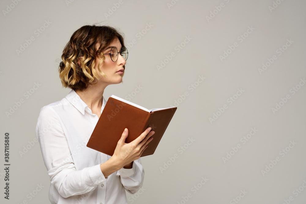woman with notepad in hands business work beige background glasses hairstyle woman with notepad in hands business work beige background glasses hairstyle