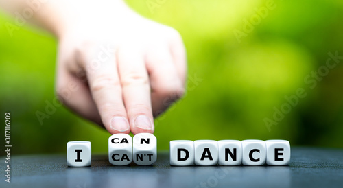 Hand turns dice and changes the expression "I can't dance" to "I can dance".
