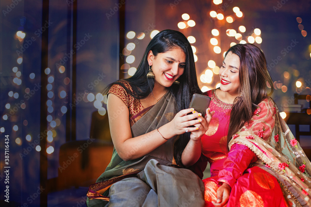 Two beautiful Indian women in ethnic clothes doing Diwali shopping