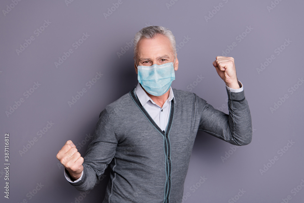 Portrait of content happy man wearing mask casual formal-wear celebrating isolated over gray pastel background Portrait of content happy man wearing mask casual formal-wear celebrating isolated over gray pastel background