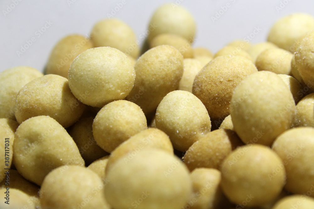 Close up savory and crunchy coated nut snacks on white background Close up savory and crunchy coated nut snacks on white background