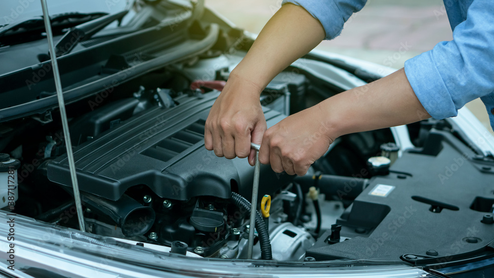 Young man's hand is repairing a car with a wrench Engineer concept and car repair Young man's hand is repairing a car with a wrench Engineer concept and car repair