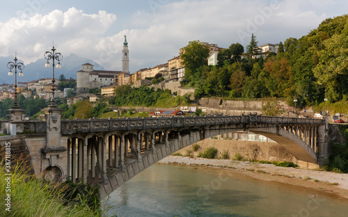 Skyline of Belluno, Italy, with the Vittoria bridge over the river Piave in the foreground
