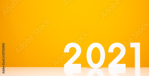 Happy new year 2021 mockup on white table and yellow background color. Celebrate with new year theme concept.