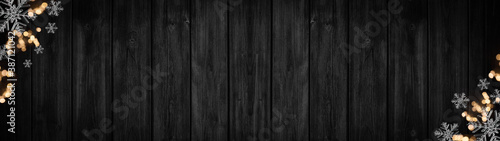 Festive decorative Christmas / Advent background banner panorama template - Bokeh lights and ice crystals, isolated on dark black rustic wooden boards wall texture, with space for text