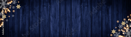Festive decorative Christmas / Advent background banner panorama template - Bokeh lights, stars and ice crystals, isolated on dark blue rustic wooden boards wall texture, with space for text