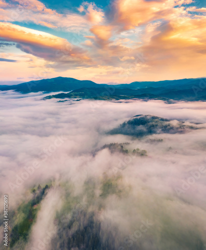 Fototapeta Naklejka Na Ścianę i Meble -  View from flying drone. Dramatic morning scene of Carpathian mountains. Great sunrise on foggy mountain valley. Beauty of nature concept background..