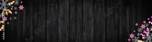 Festive decorative Christmas   Advent background banner panorama template - Bokeh lights  stars and ice crystals  isolated on dark black rustic wooden boards wall texture  with space for text